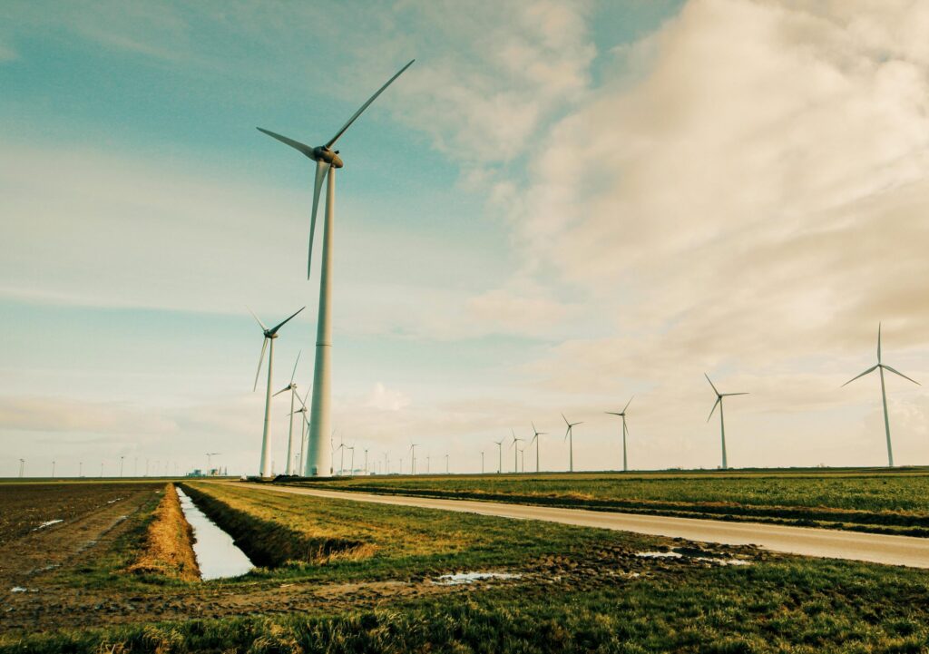 Scenic view of wind turbines in a rural Dutch landscape, generating renewable energy.